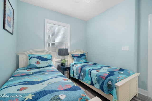 bedroom featuring hardwood / wood-style flooring and ceiling fan