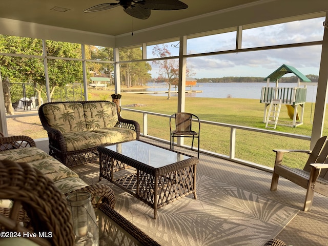 sunroom featuring a water view and ceiling fan