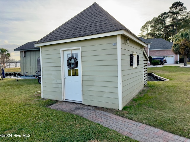 view of outbuilding featuring a garage and a lawn