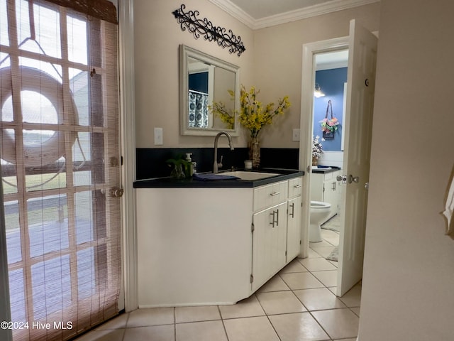 bathroom with vanity, tile patterned floors, toilet, and crown molding