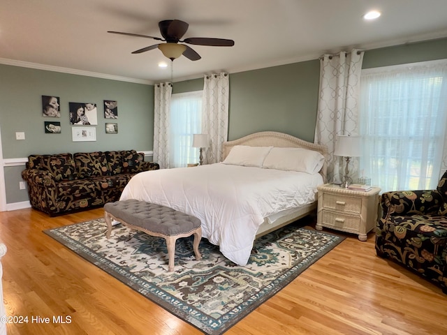 bedroom with ceiling fan, wood-type flooring, and ornamental molding