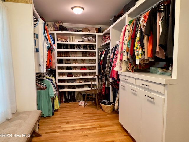 walk in closet with light wood-type flooring