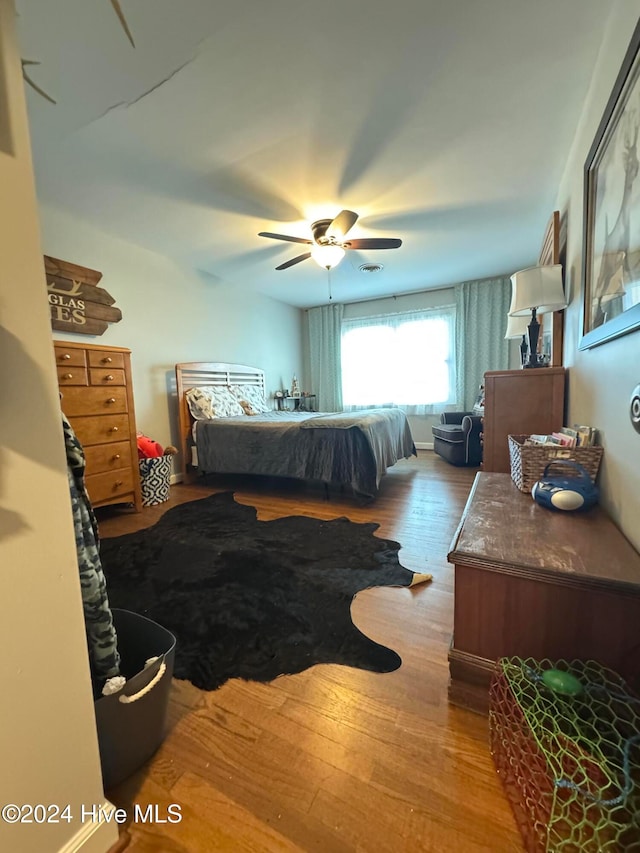 bedroom with ceiling fan and light hardwood / wood-style flooring