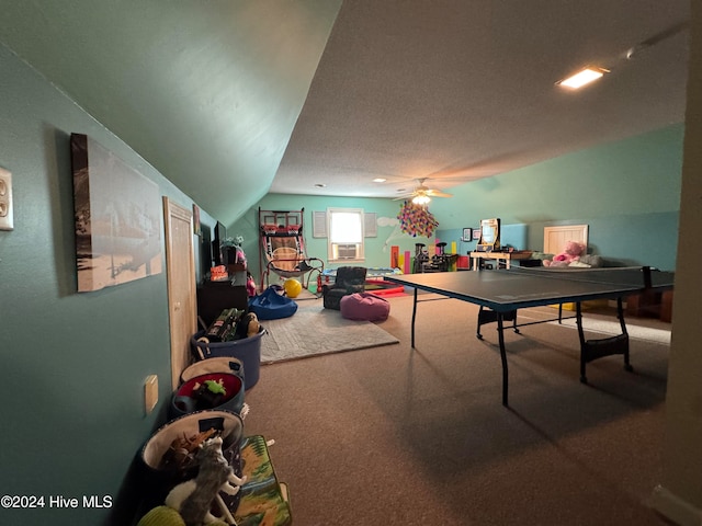 recreation room with ceiling fan, cooling unit, carpet flooring, and lofted ceiling