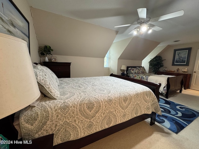 carpeted bedroom with ceiling fan and lofted ceiling