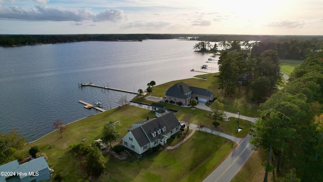 aerial view at dusk featuring a water view