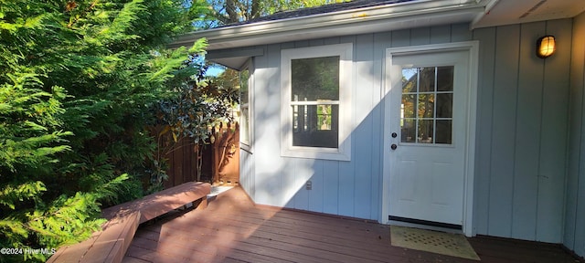 view of exterior entry with a deck