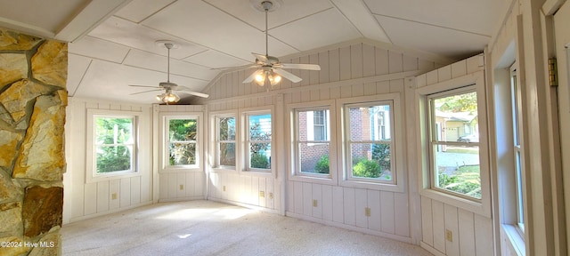 unfurnished sunroom featuring vaulted ceiling, ceiling fan, and plenty of natural light