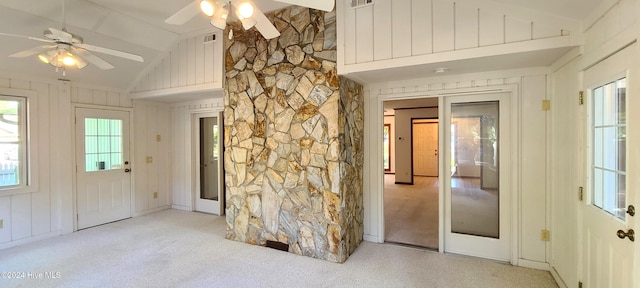 empty room featuring ceiling fan, light carpet, and lofted ceiling