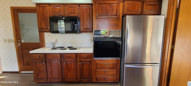 kitchen featuring black appliances and dark hardwood / wood-style floors