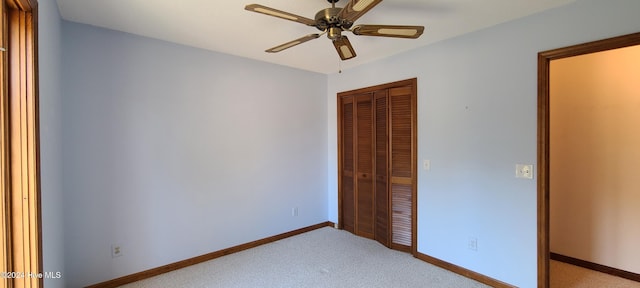 unfurnished bedroom with ceiling fan, a closet, and light colored carpet