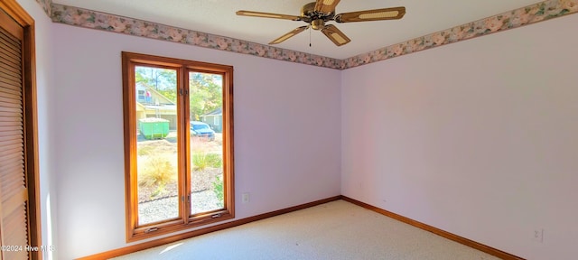 empty room with ceiling fan and carpet floors