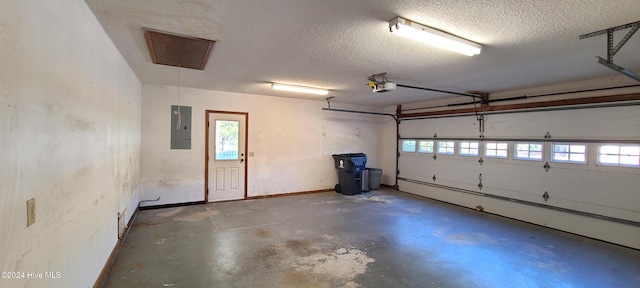 garage featuring electric panel and a garage door opener