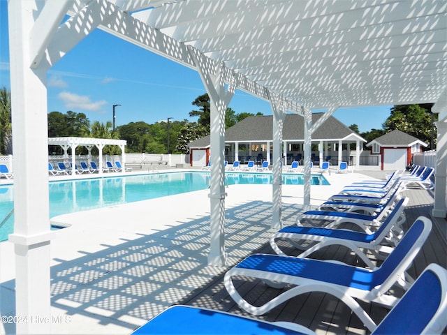 view of pool featuring an outbuilding and a patio