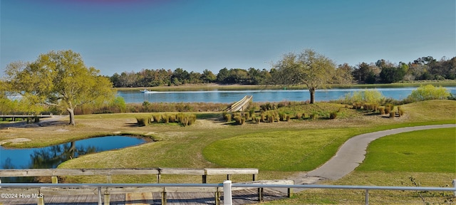 view of property's community featuring a water view and a yard