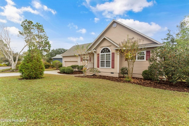 view of front of home featuring a front yard and a garage