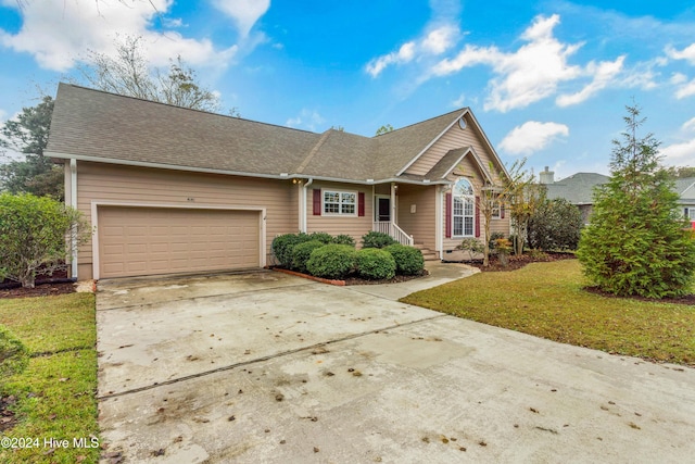 ranch-style house with a garage and a front lawn