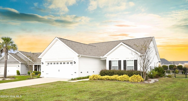 view of front of house with a lawn and a garage