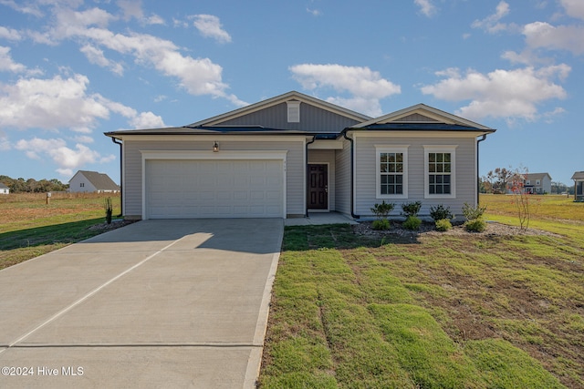 view of front of house featuring a garage and a front lawn