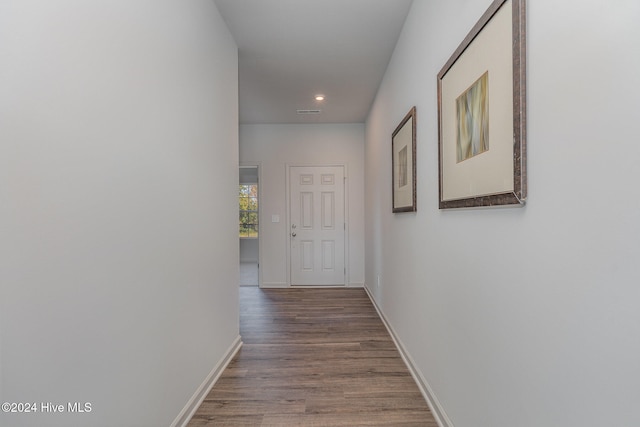 hall with hardwood / wood-style flooring