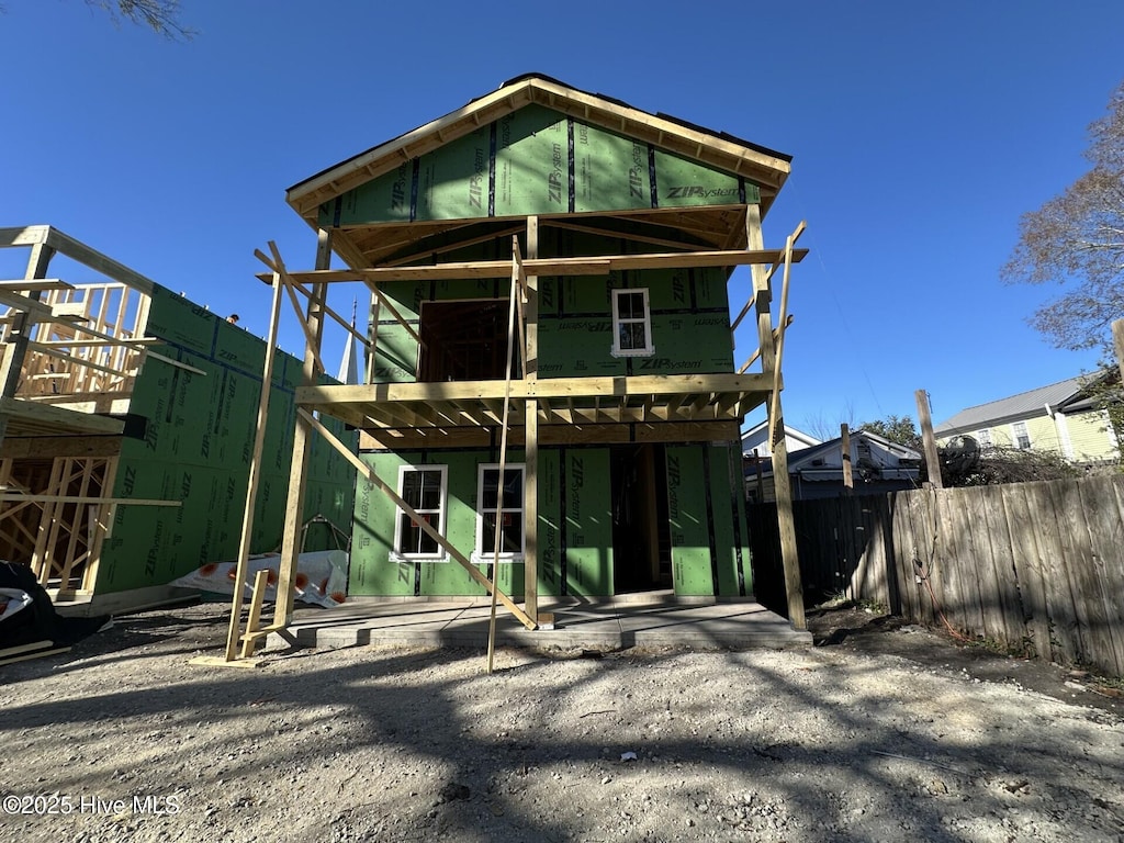 rear view of house with fence