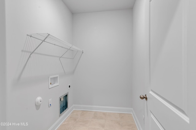 laundry room with gas dryer hookup, hookup for a washing machine, hookup for an electric dryer, and light tile patterned floors