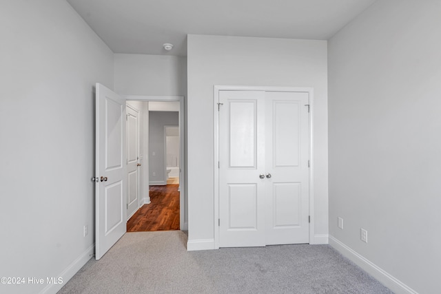 unfurnished bedroom with carpet and a closet