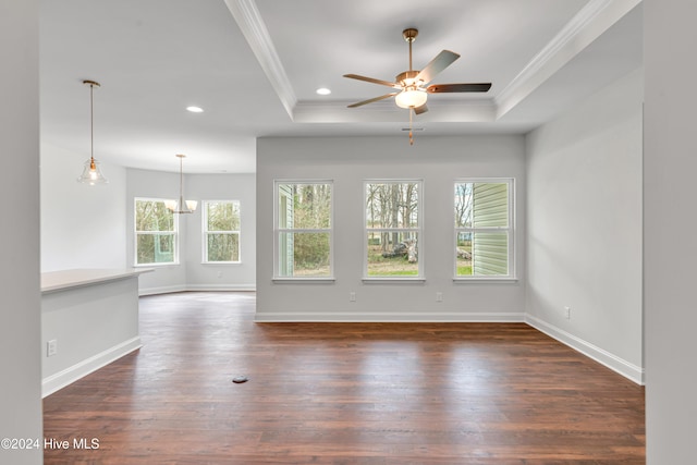 unfurnished room with dark wood-type flooring, a tray ceiling, and crown molding