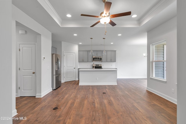 unfurnished living room with dark wood-type flooring, ceiling fan, crown molding, and a raised ceiling