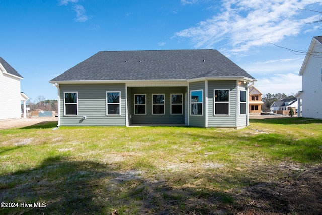 back of house with a yard