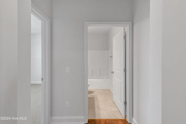 hallway with light hardwood / wood-style floors