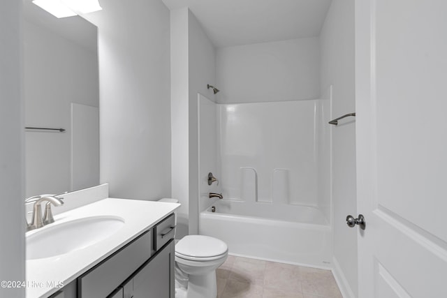 full bathroom featuring toilet, washtub / shower combination, vanity, and tile patterned flooring