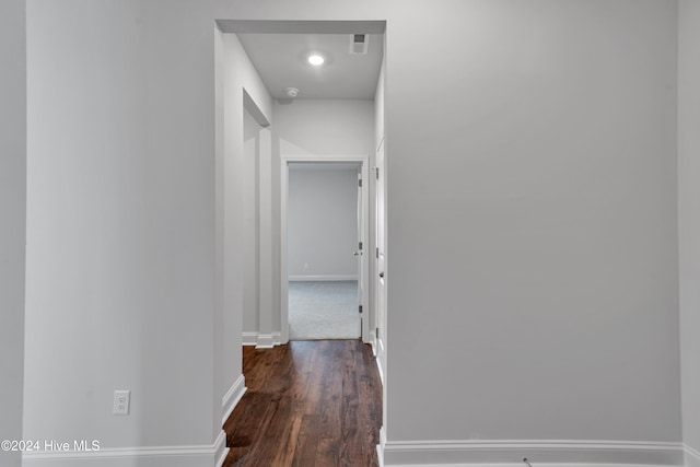 hallway with dark hardwood / wood-style flooring