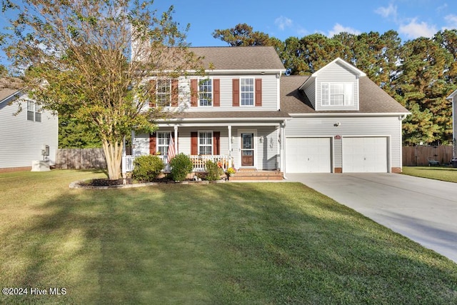 colonial inspired home with a garage, a front yard, and covered porch