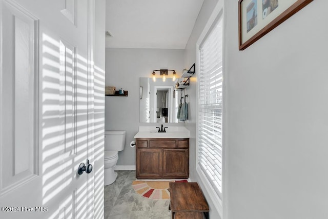 bathroom featuring vanity and toilet