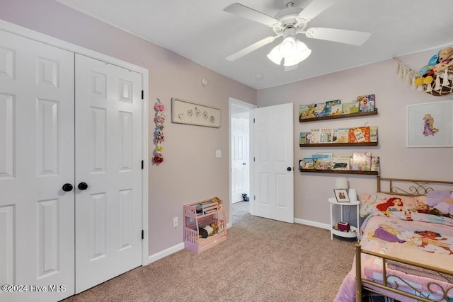 bedroom with a closet, light carpet, and ceiling fan