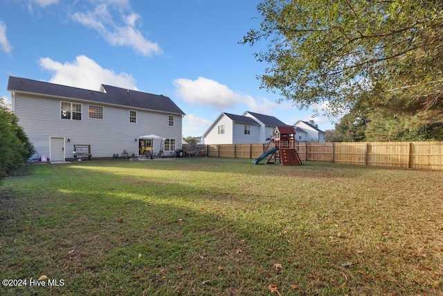 exterior space featuring a playground and a yard