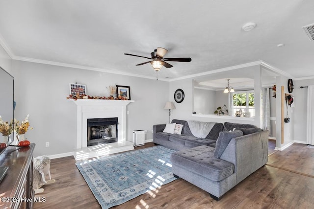 living room with dark wood-type flooring, ceiling fan, and ornamental molding