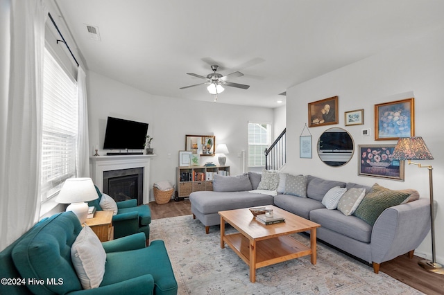 living room featuring light wood-type flooring and ceiling fan