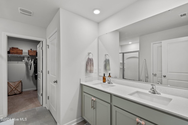 bathroom with walk in shower and vanity