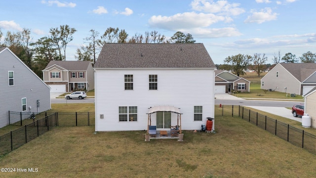 rear view of property featuring a yard