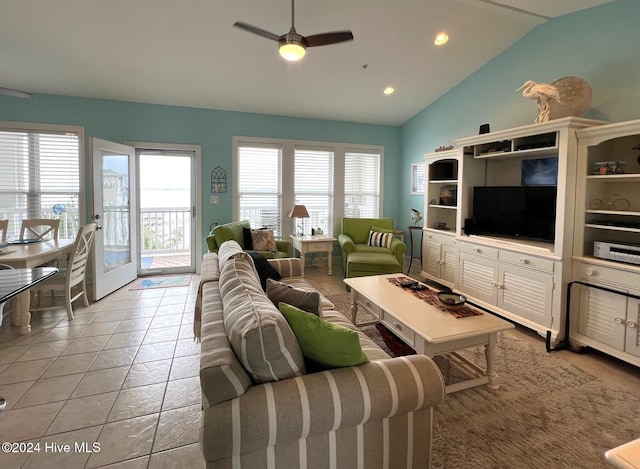 tiled living room featuring ceiling fan, lofted ceiling, and a healthy amount of sunlight