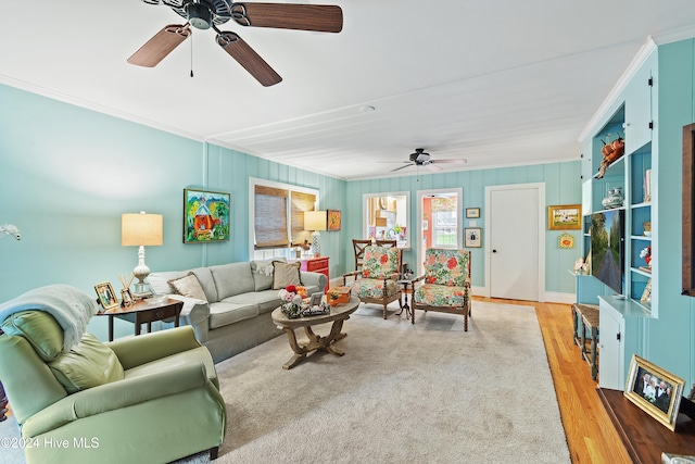 living room with hardwood / wood-style floors, ceiling fan, and ornamental molding