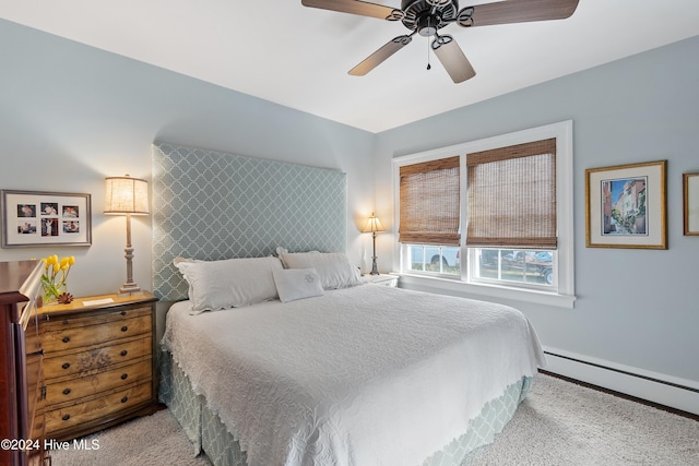 carpeted bedroom with baseboard heating and ceiling fan