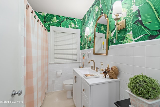 bathroom featuring tile walls, vanity, tile patterned floors, and toilet