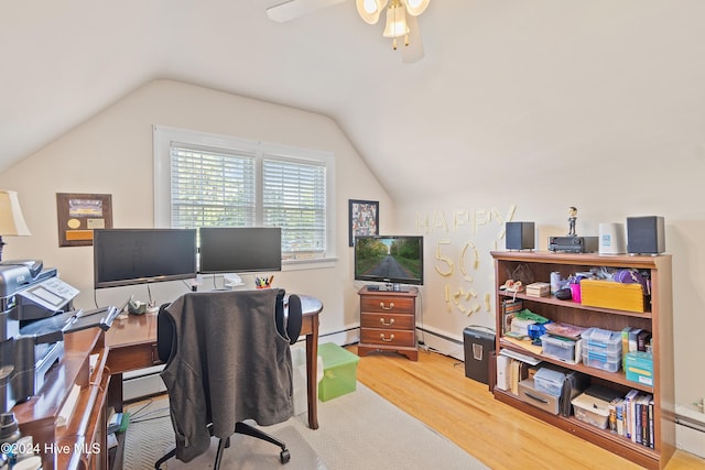 home office featuring vaulted ceiling, hardwood / wood-style flooring, ceiling fan, and a baseboard heating unit