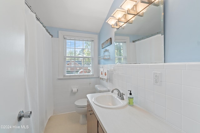 bathroom featuring tile walls, vanity, tile patterned floors, and toilet