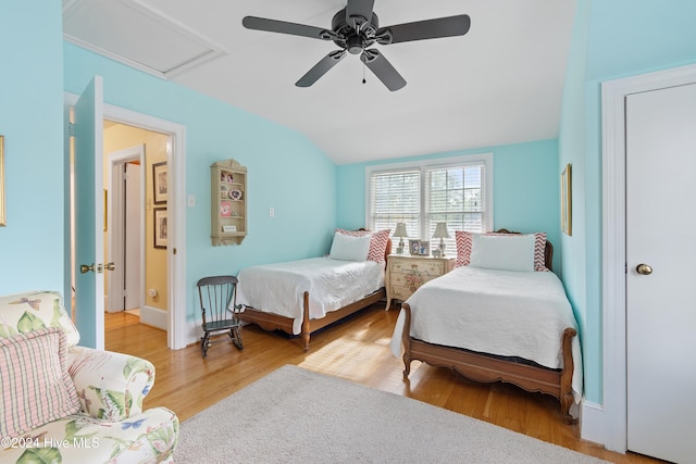 bedroom with wood-type flooring, ceiling fan, and vaulted ceiling