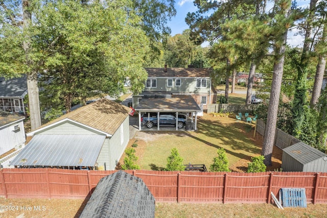 exterior space with a carport and a front lawn