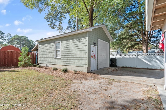 garage featuring a lawn